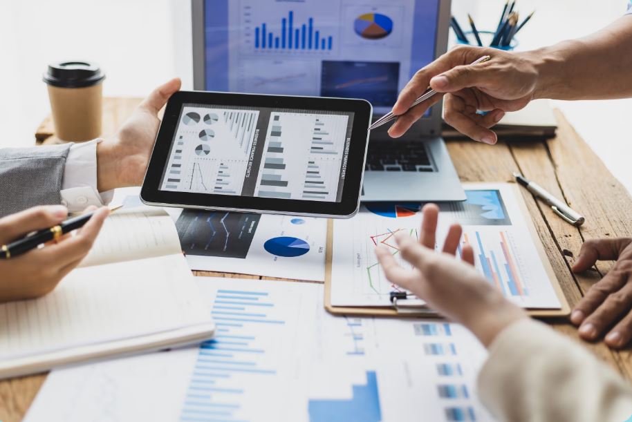 Procurement professionals reviewing cost analysis data